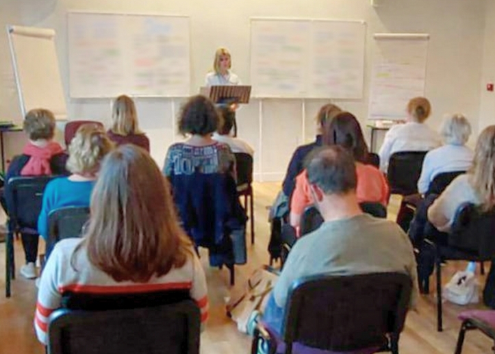 Carole animant une conférence sur la cohérence émotionnelle devant un groupe en atelier TADAM